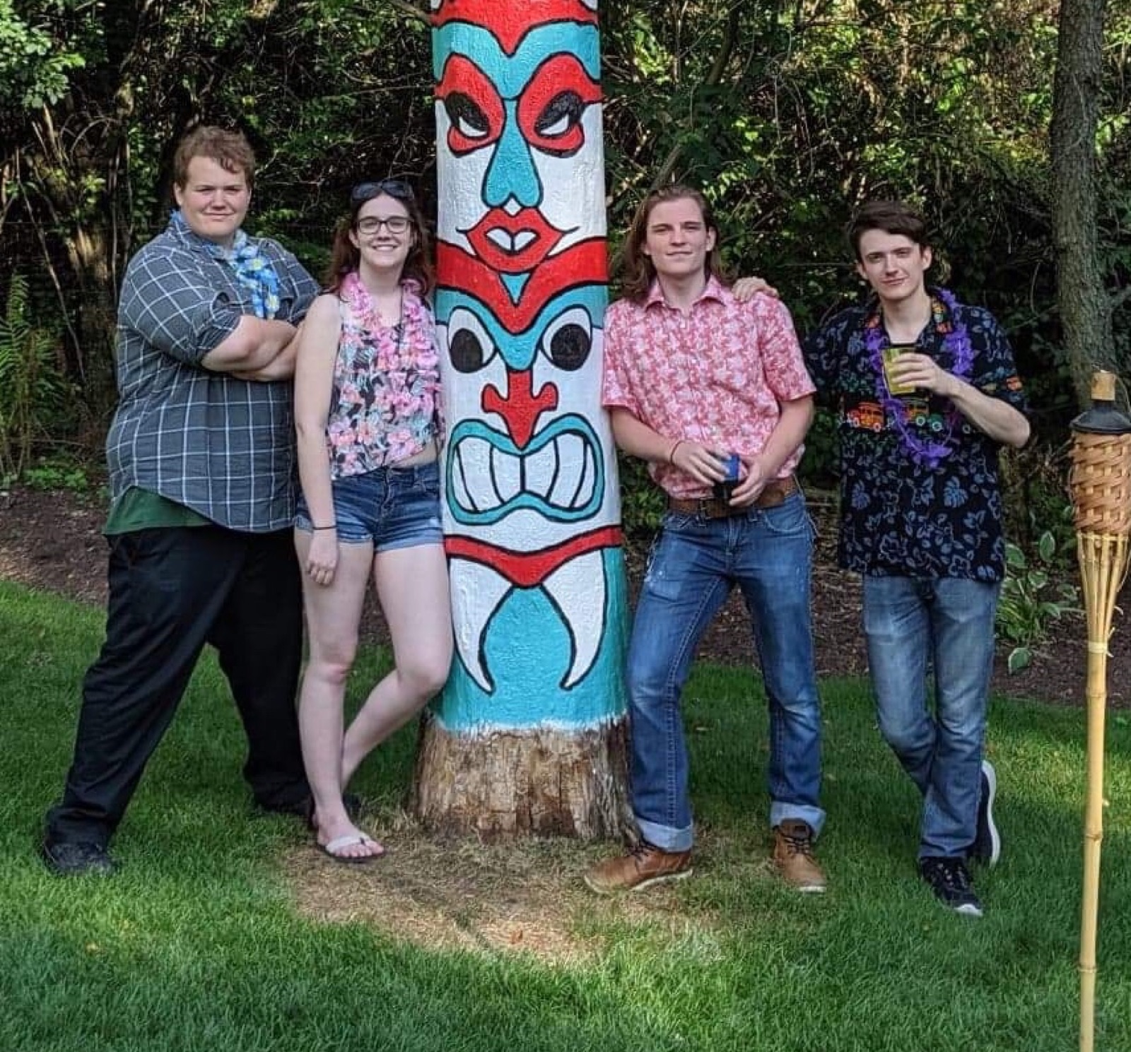 Ian and Nicole with friends by a painted totem pole